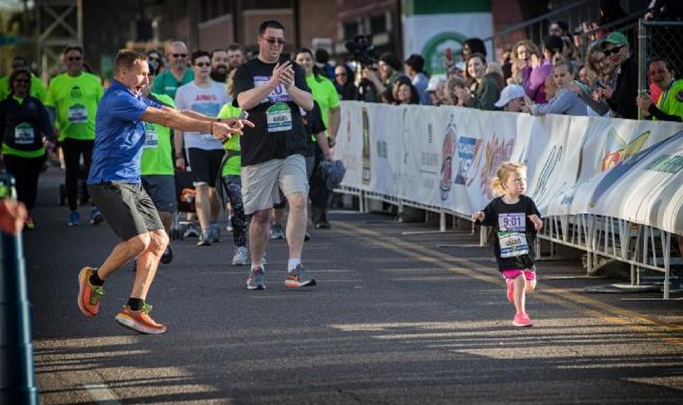A Man Focusing On A Young Kid and Rest Clapping For Him