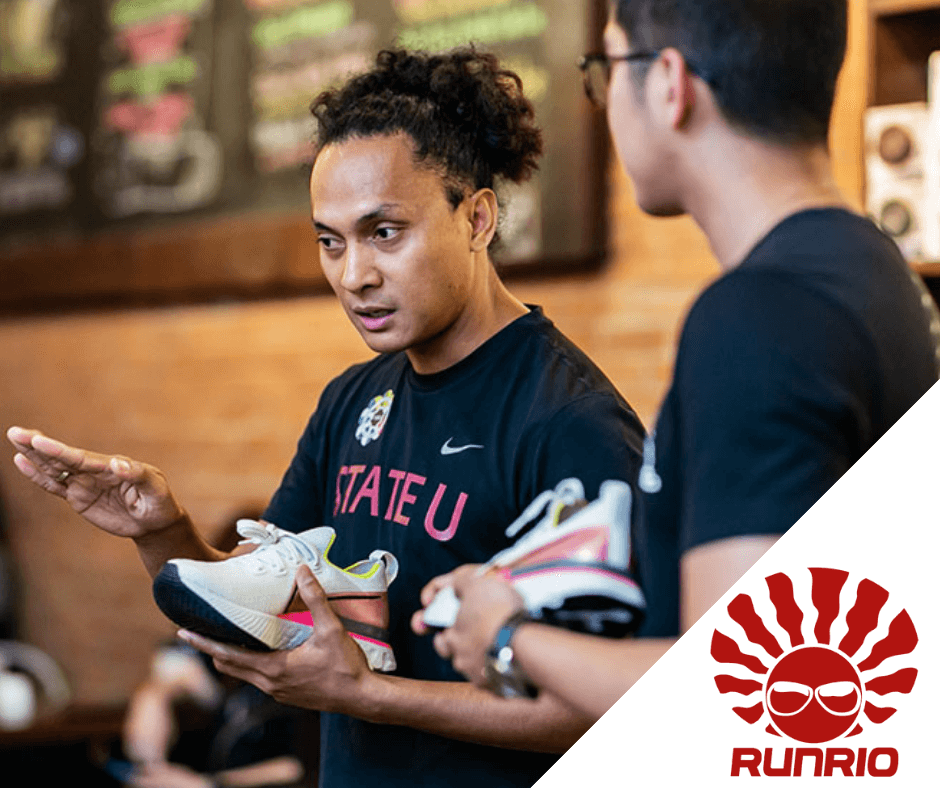 Two Man Holding Sports Shoes In Their Hand